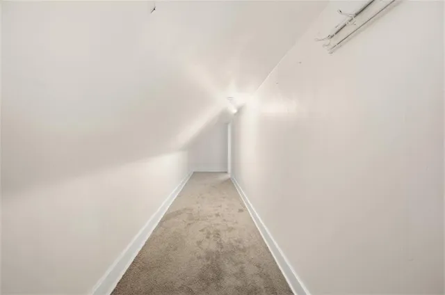 a view of empty room with wooden walls