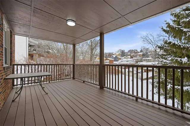 a view of porch with a floor to ceiling window with wooden floor