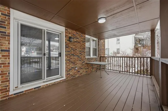 a view of a balcony with wooden floor
