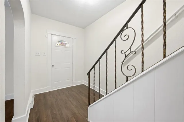 a view of an entryway with wooden floor