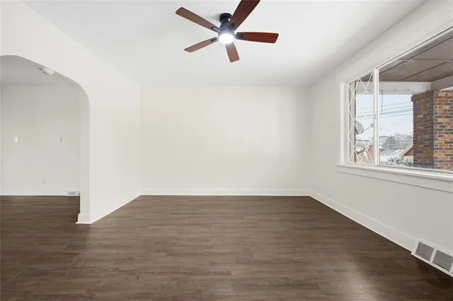 a view of empty room with wooden floor