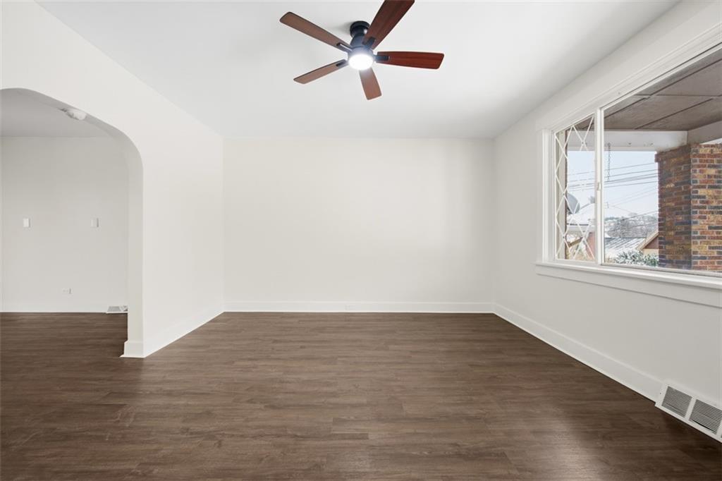 127 Duffland Street Pittsburgh, PA 15210 - Photo 8 of 36 an empty room with wooden floor fan and windows