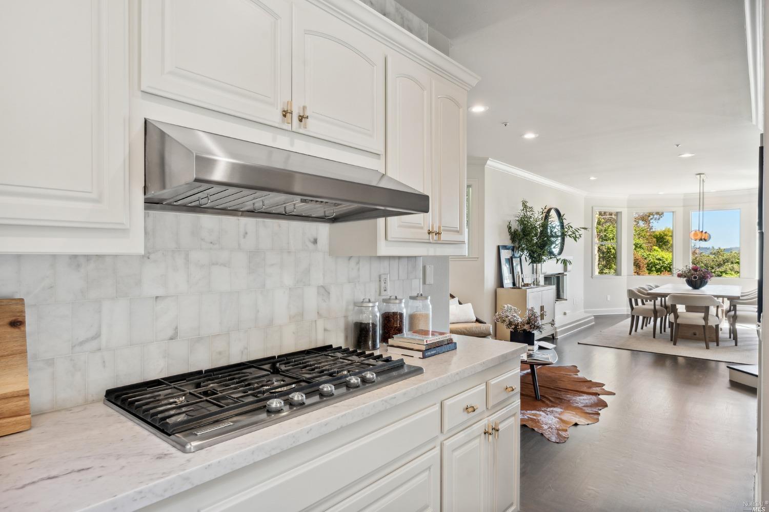 2 Spring Hill Circle Sausalito, CA 94965 - Photo 23 of 57 a kitchen with stainless steel appliances granite countertop a stove a sink dishwasher and white cabinets with wooden floor