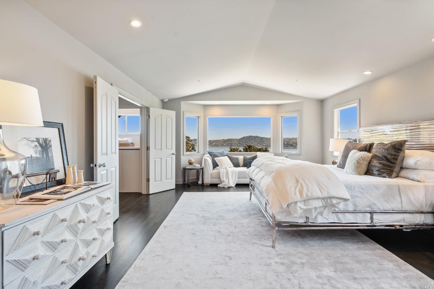 2 Spring Hill Circle Sausalito, CA 94965 - Photo 33 of 57 a spacious bedroom with a bed and a large mirror