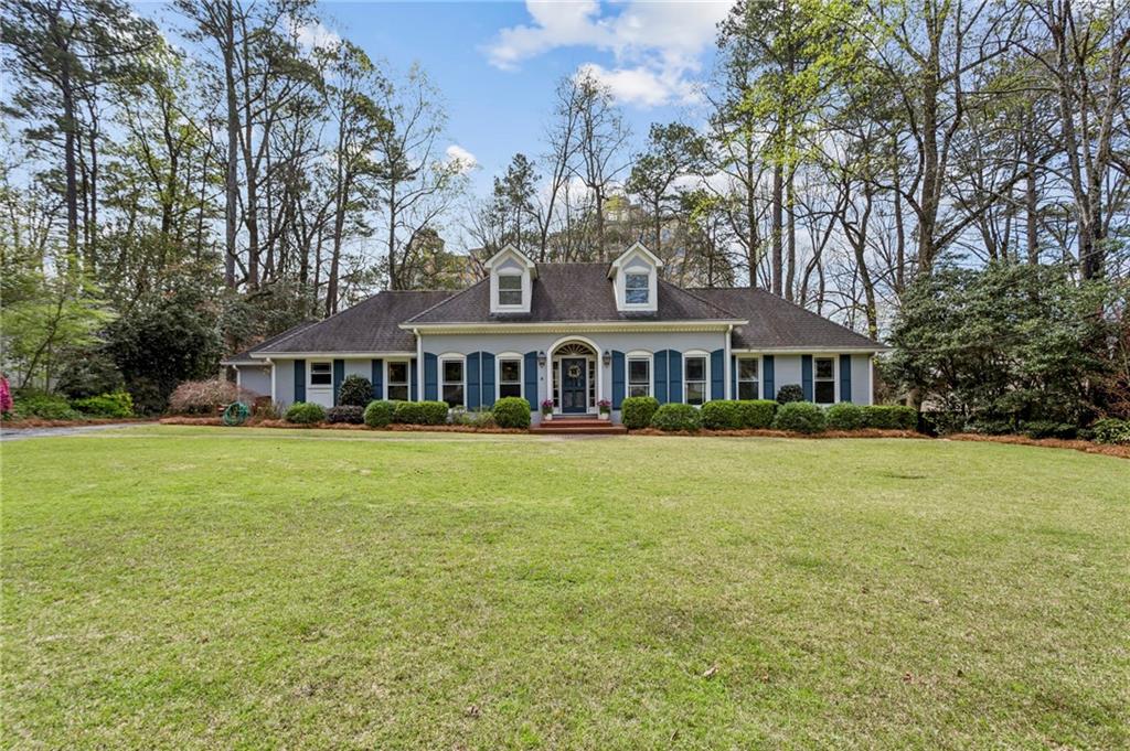 3384 Pine Meadow Road Northwest Atlanta, GA 30327 - Photo 1 of 56 a front view of a house with a garden