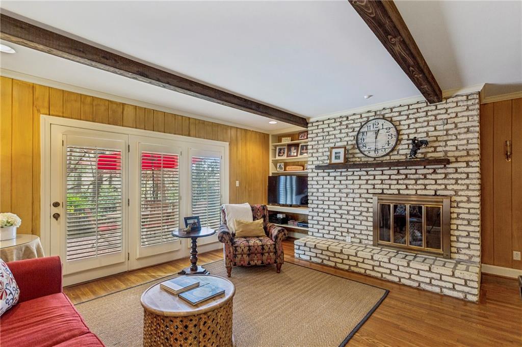3384 Pine Meadow Road Northwest Atlanta, GA 30327 - Photo 14 of 56 a living room with furniture a rug and a fireplace
