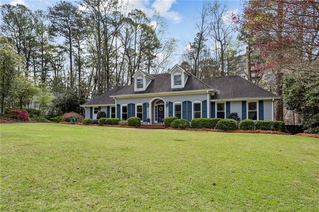 3384 Pine Meadow Road Northwest Atlanta, GA 30327 - Photo 2 of 56 a front view of a house with garden