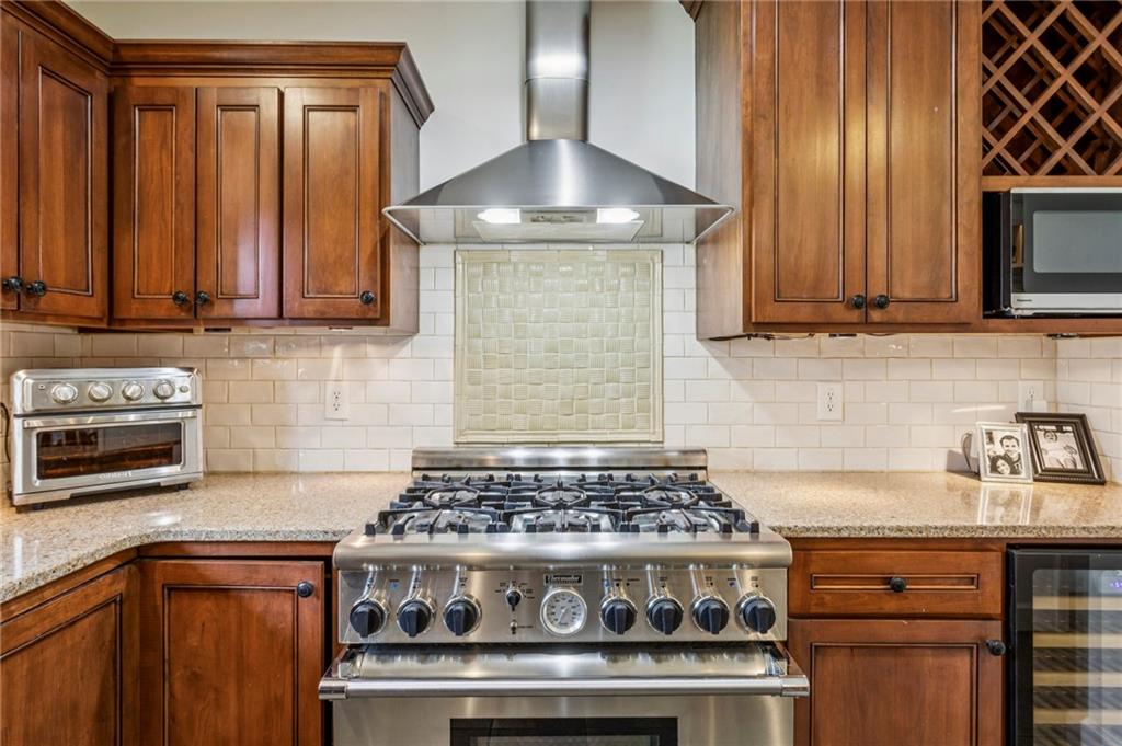 3384 Pine Meadow Road Northwest Atlanta, GA 30327 - Photo 23 of 56 a kitchen with granite countertop a stove top oven cabinetry a sink and a window