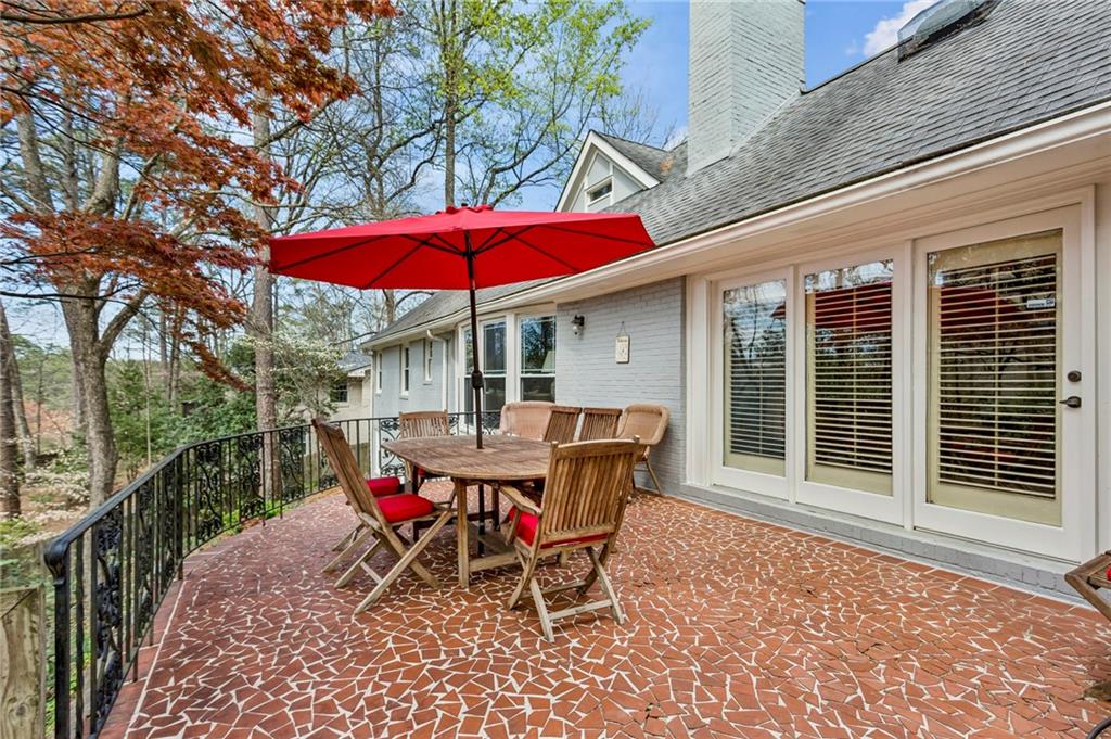 3384 Pine Meadow Road Northwest Atlanta, GA 30327 - Photo 26 of 56 a view of a table and chairs under an umbrella in the patio