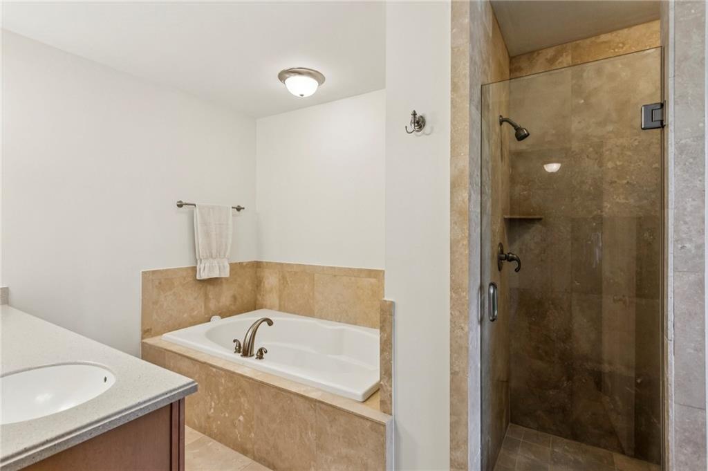 3384 Pine Meadow Road Northwest Atlanta, GA 30327 - Photo 33 of 56 a bathroom with a tub a sink and a shower