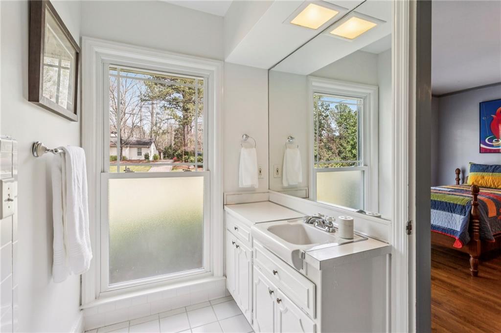3384 Pine Meadow Road Northwest Atlanta, GA 30327 - Photo 35 of 56 a bathroom with a granite countertop sink and a mirror