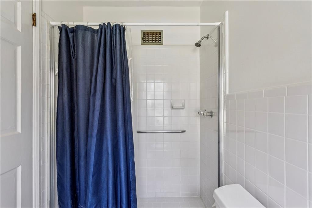 3384 Pine Meadow Road Northwest Atlanta, GA 30327 - Photo 36 of 56 a bathroom with a shower and a door