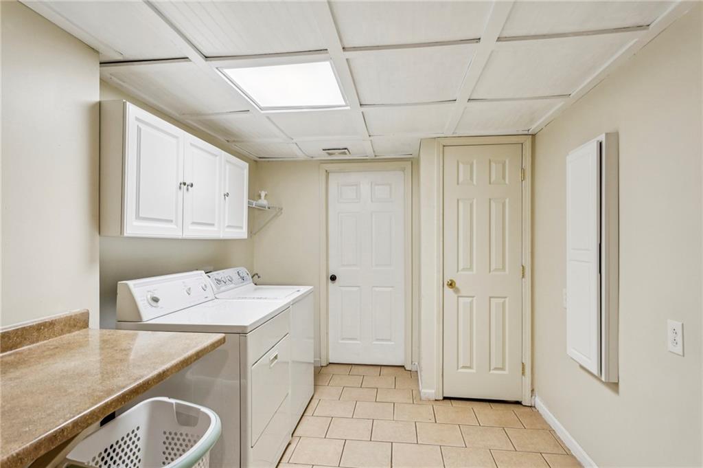 3384 Pine Meadow Road Northwest Atlanta, GA 30327 - Photo 51 of 56 a utility room with cabinets washer and dryer