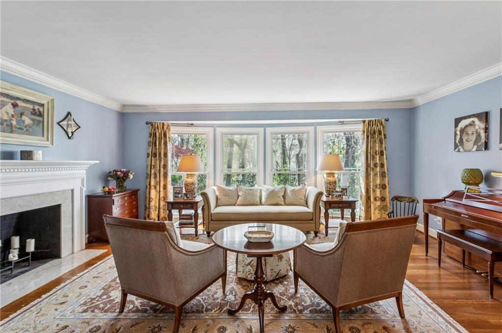 3384 Pine Meadow Road Northwest Atlanta, GA 30327 - Photo 10 of 56 a living room with furniture a fireplace and a table