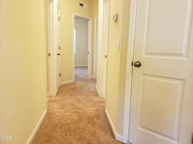 a view of a bathroom from a hallway
