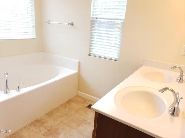 a bath tub sitting in a bathroom next to a window