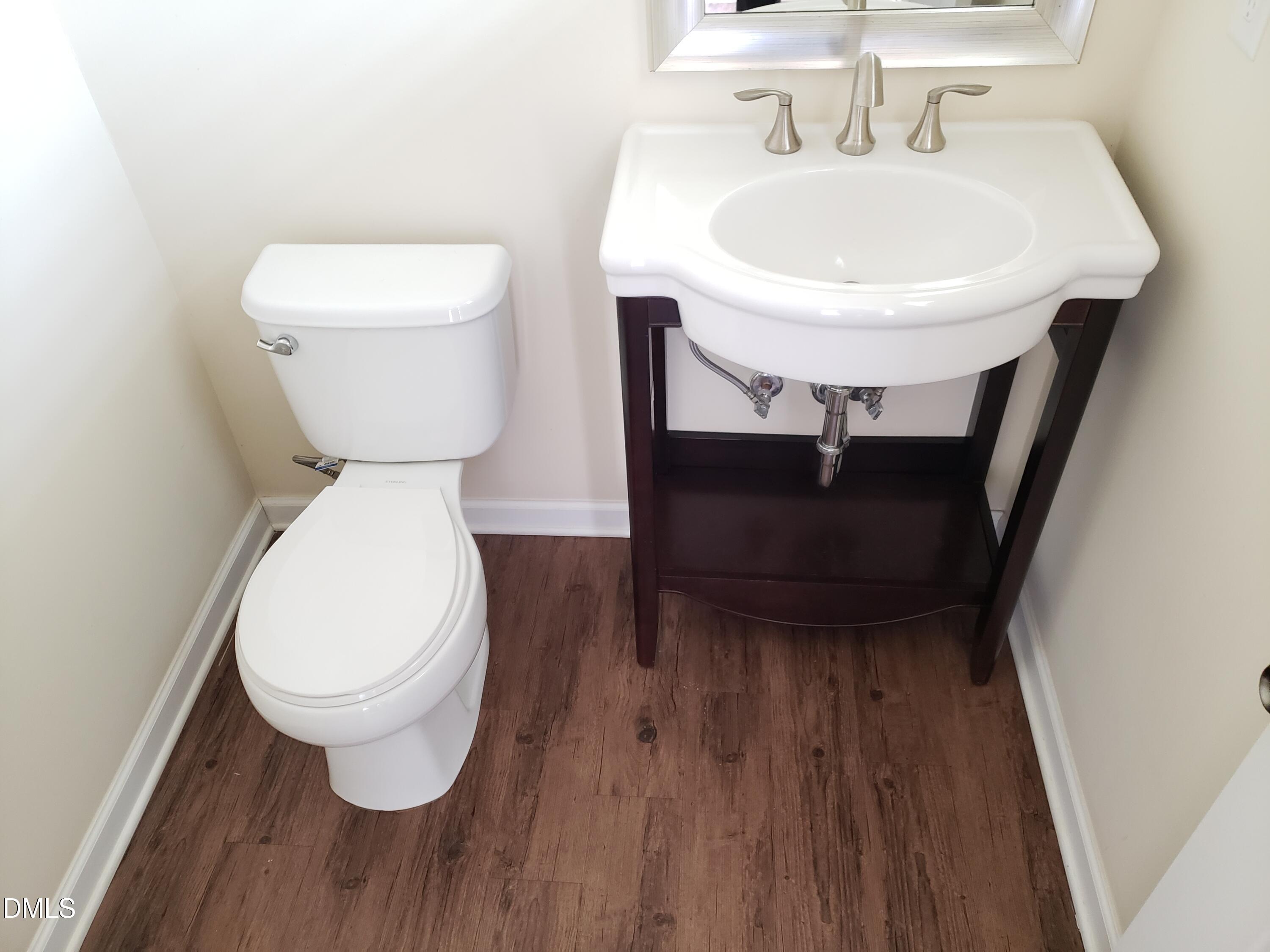 16 Grifton Place Durham, NC 27704 - Photo 6 of 16 a bathroom with a toilet sink and mirror