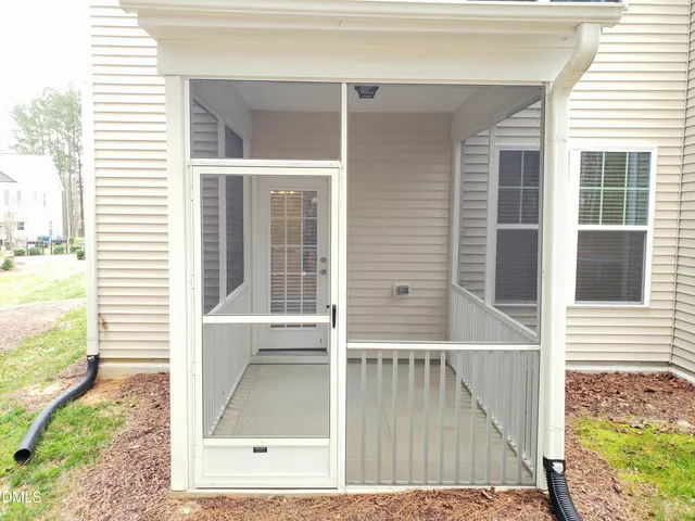 a view of a balcony with a floor to ceiling window and wooden floor