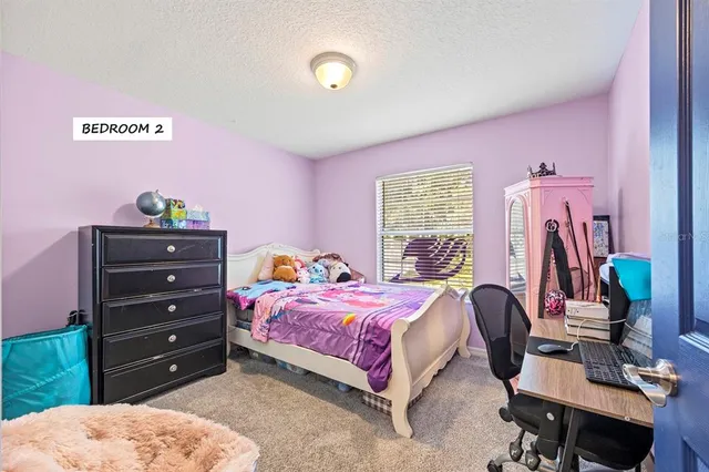 a bedroom with a bed and a desk