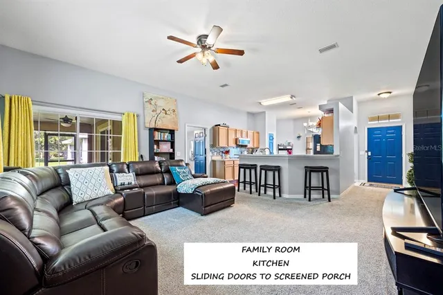 a living room with furniture a table and a flat screen tv