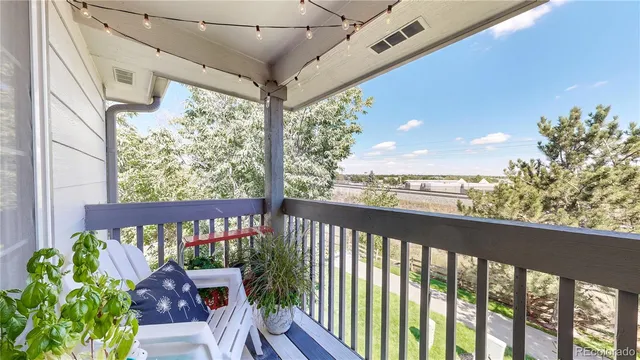 a view of a balcony with furniture