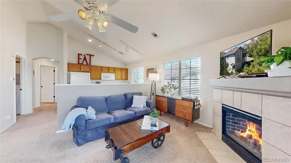 a living room with furniture a fireplace and a flat screen tv