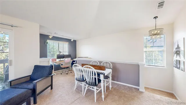 a dining room with furniture and window
