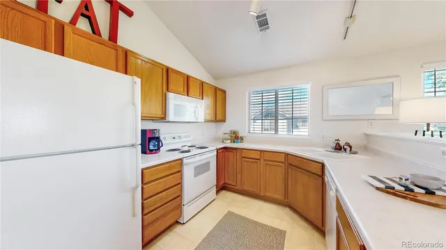 a kitchen with a sink a stove and a refrigerator
