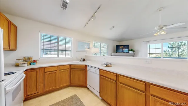 a kitchen with lots of counter top space and windows
