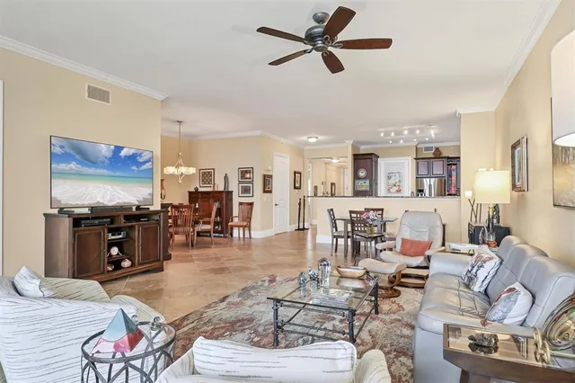 a view of a livingroom with furniture wooden floor and a chandelier