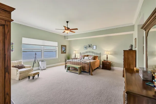 a spacious bedroom with a bed a couch and bookshelf