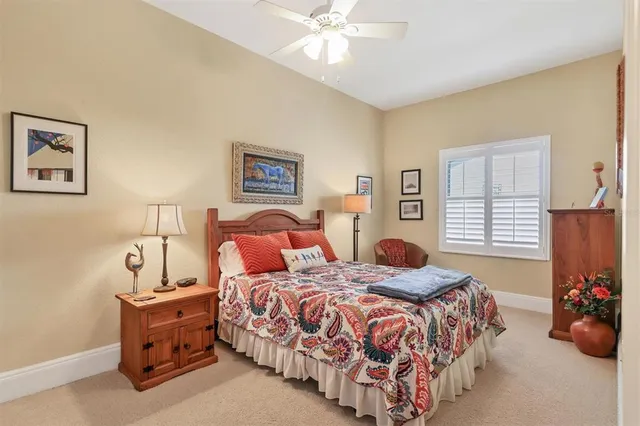 a bathroom with a granite countertop sink toilet a mirror and shower curtain