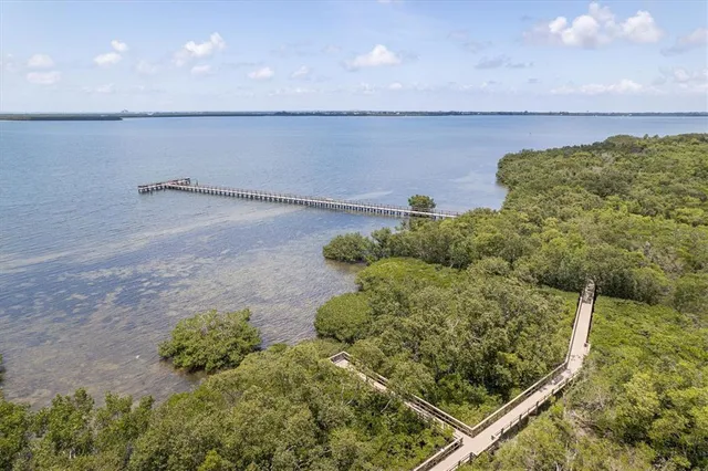 an aerial view of a swimming pool with outdoor seating