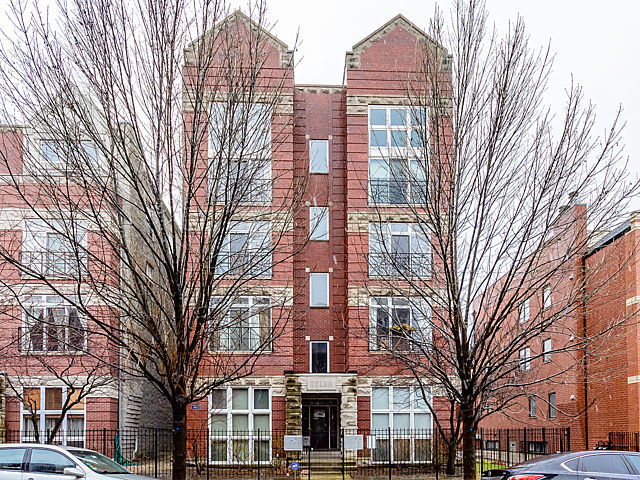 2127 West Rice Street, Unit 4E Chicago, IL 60622 - Photo 1 of 23 a front view of a building with large trees