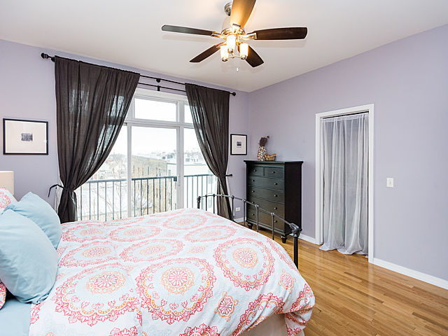 2127 West Rice Street, Unit 4E Chicago, IL 60622 - Photo 12 of 23 a bedroom with a large bed and a large window
