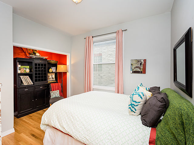 2127 West Rice Street, Unit 4E Chicago, IL 60622 - Photo 16 of 23 a bedroom with a bed dresser and a window
