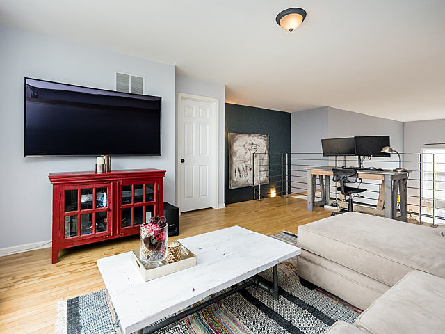 2127 West Rice Street, Unit 4E Chicago, IL 60622 - Photo 19 of 23 a living room with furniture and a flat screen tv