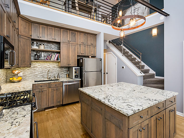 2127 West Rice Street, Unit 4E Chicago, IL 60622 - Photo 4 of 23 a kitchen with stainless steel appliances granite countertop a sink stove and refrigerator