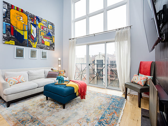 2127 West Rice Street, Unit 4E Chicago, IL 60622 - Photo 6 of 23 a living room with furniture and a floor to ceiling window