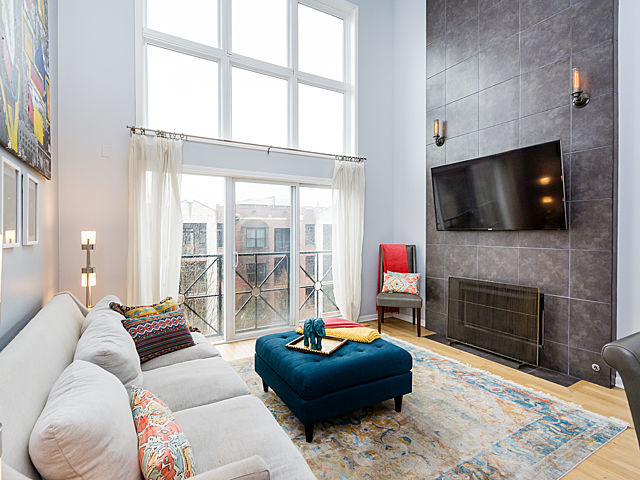 2127 West Rice Street, Unit 4E Chicago, IL 60622 - Photo 7 of 23 a living room with fireplace furniture and a flat screen tv