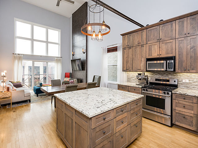 2127 West Rice Street, Unit 4E Chicago, IL 60622 - Photo 8 of 23 a kitchen with stainless steel appliances granite countertop a stove and more cabinets