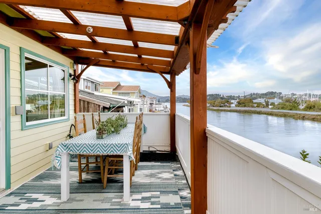 a outdoor view of a house with lake view and a floor to ceiling window