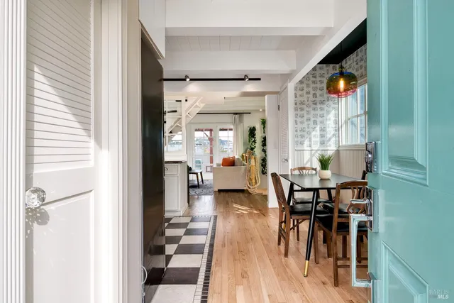 a view of a dining room with furniture wooden floor and a chandelier