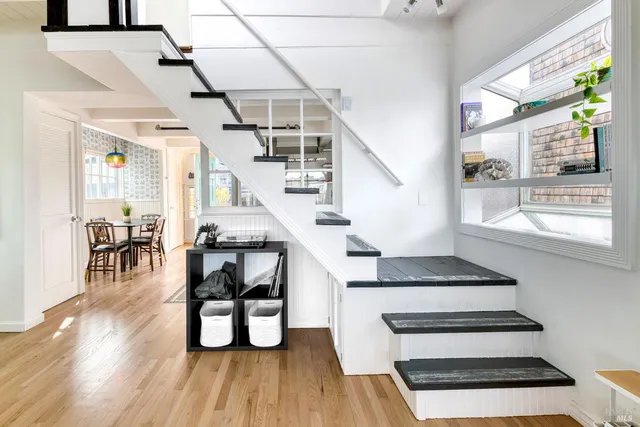 a view of a chairs and table on the roof deck