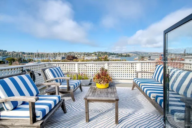 a view of a balcony dining area with furniture