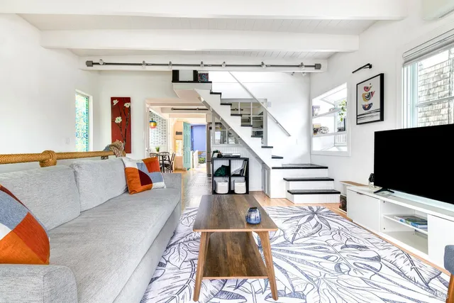 a living room with lots of furniture and a flat screen tv