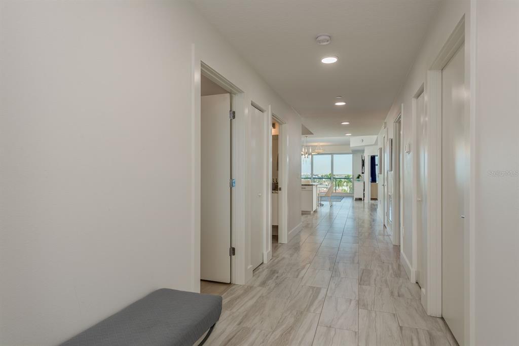 415 Island Way, Unit 402 Clearwater Beach, FL 33767 - Photo 14 of 35 a view of a hallway with wooden floor
