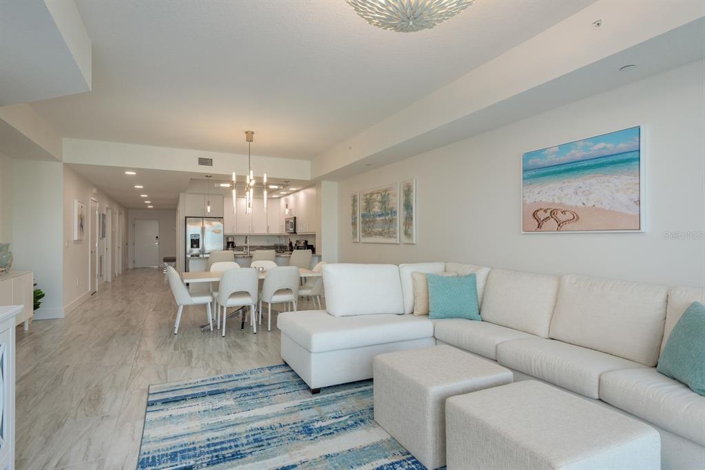 415 Island Way, Unit 402 Clearwater Beach, FL 33767 - Photo 16 of 35 a living room with furniture wooden floor and dining table