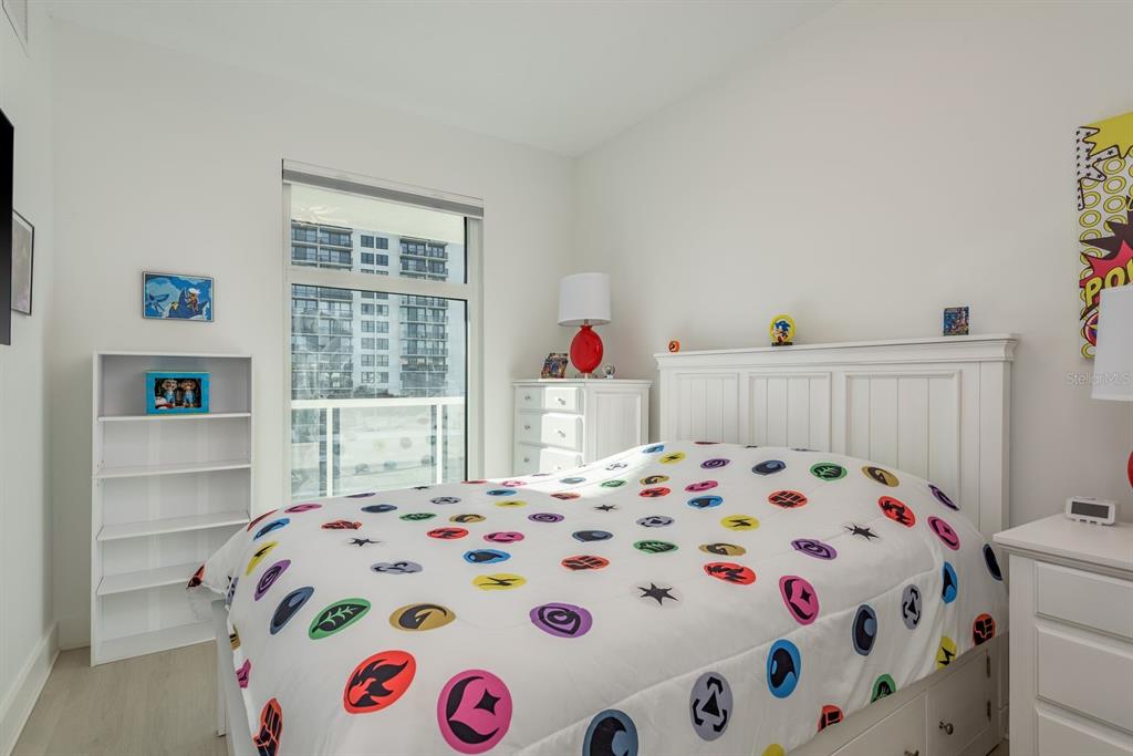 415 Island Way, Unit 402 Clearwater Beach, FL 33767 - Photo 24 of 35 a bedroom with a bed and a window