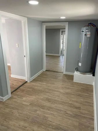 a front view of a house with a tree